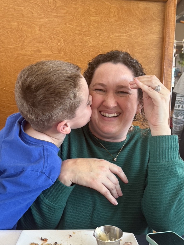 Kelly's son kissing her on the cheek