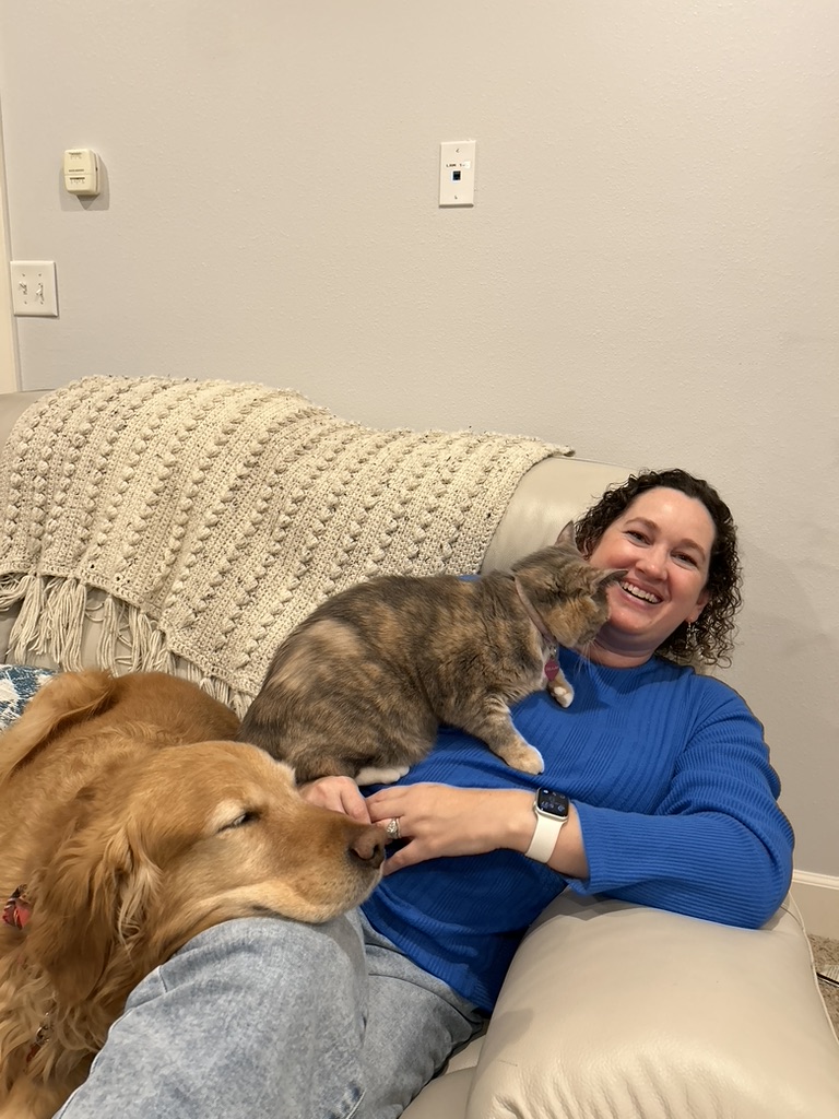 Kelly with her golden retriever and cat