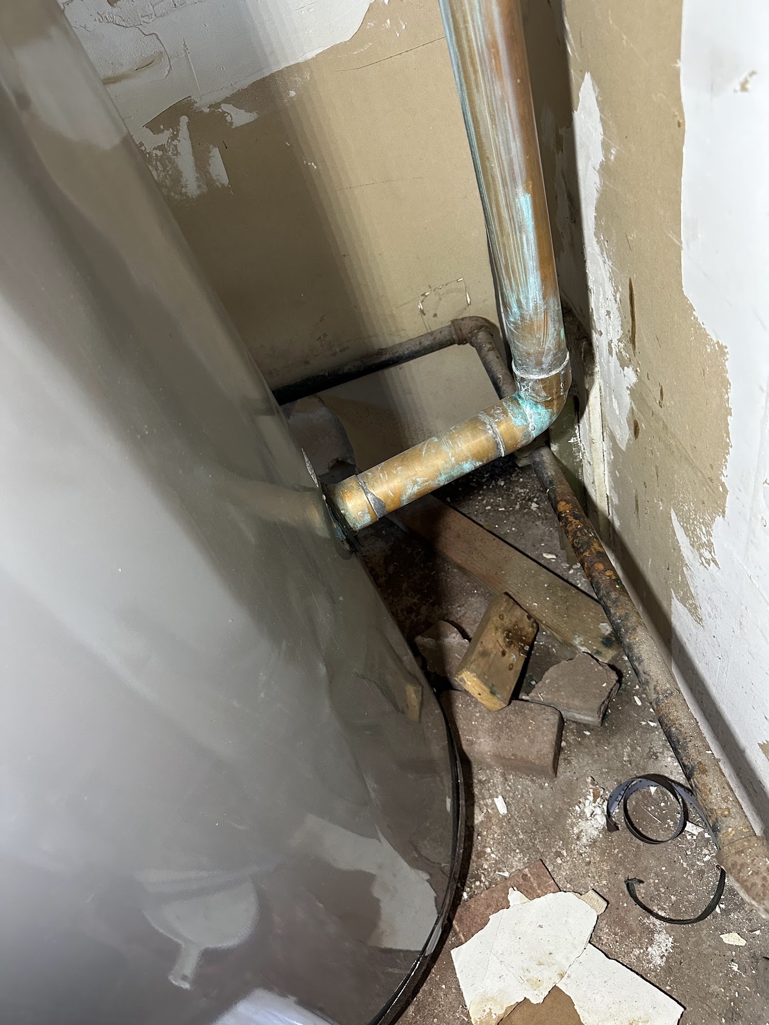 Wall opened at floor level exposing a leaking pipe in a Houston home