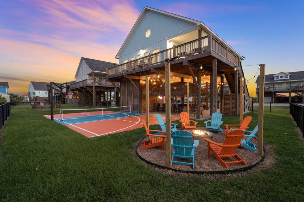 The backyard: pickleball court, covered tiki lounge and fire pit