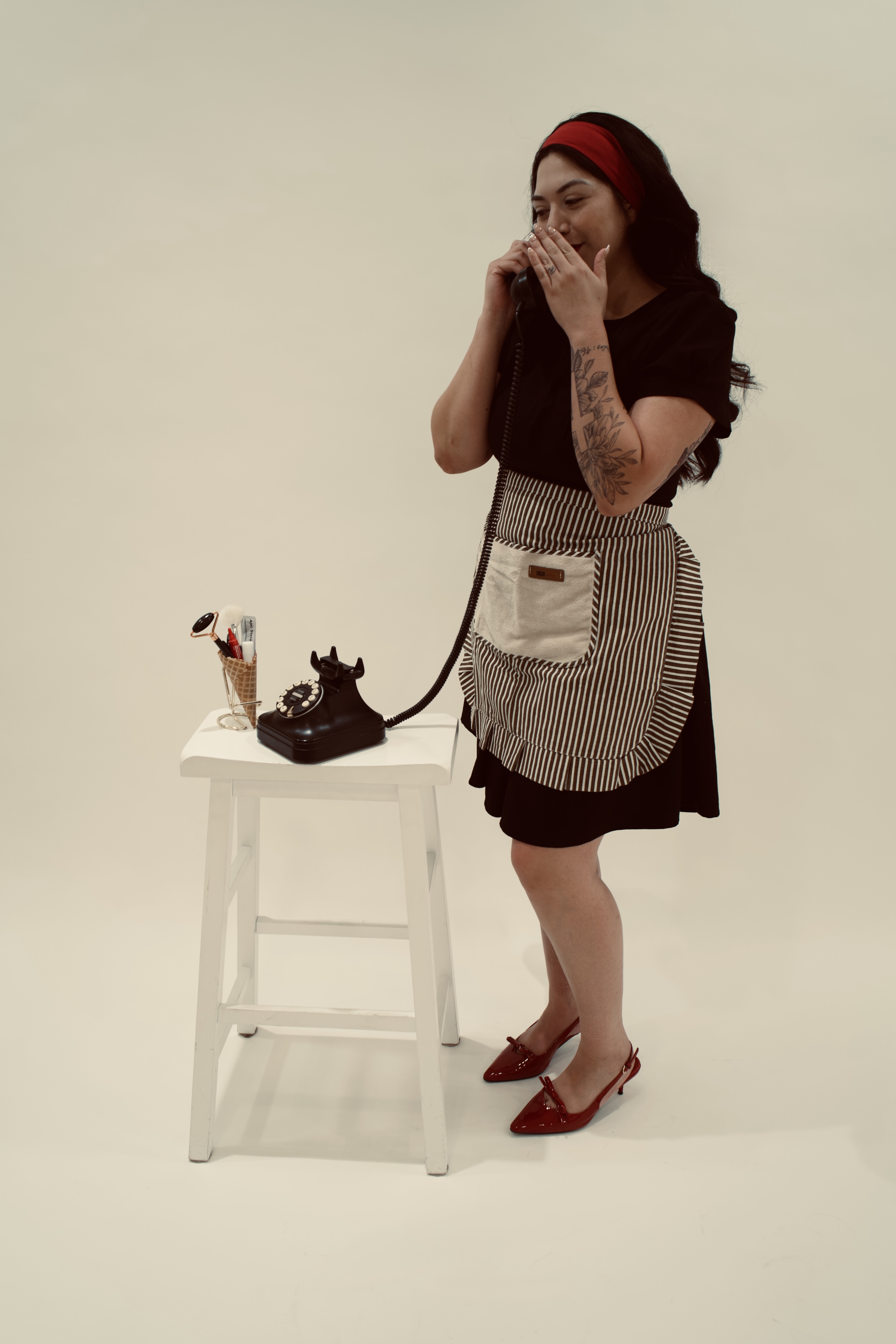 Bianca smiling while speaking on a vintage phone