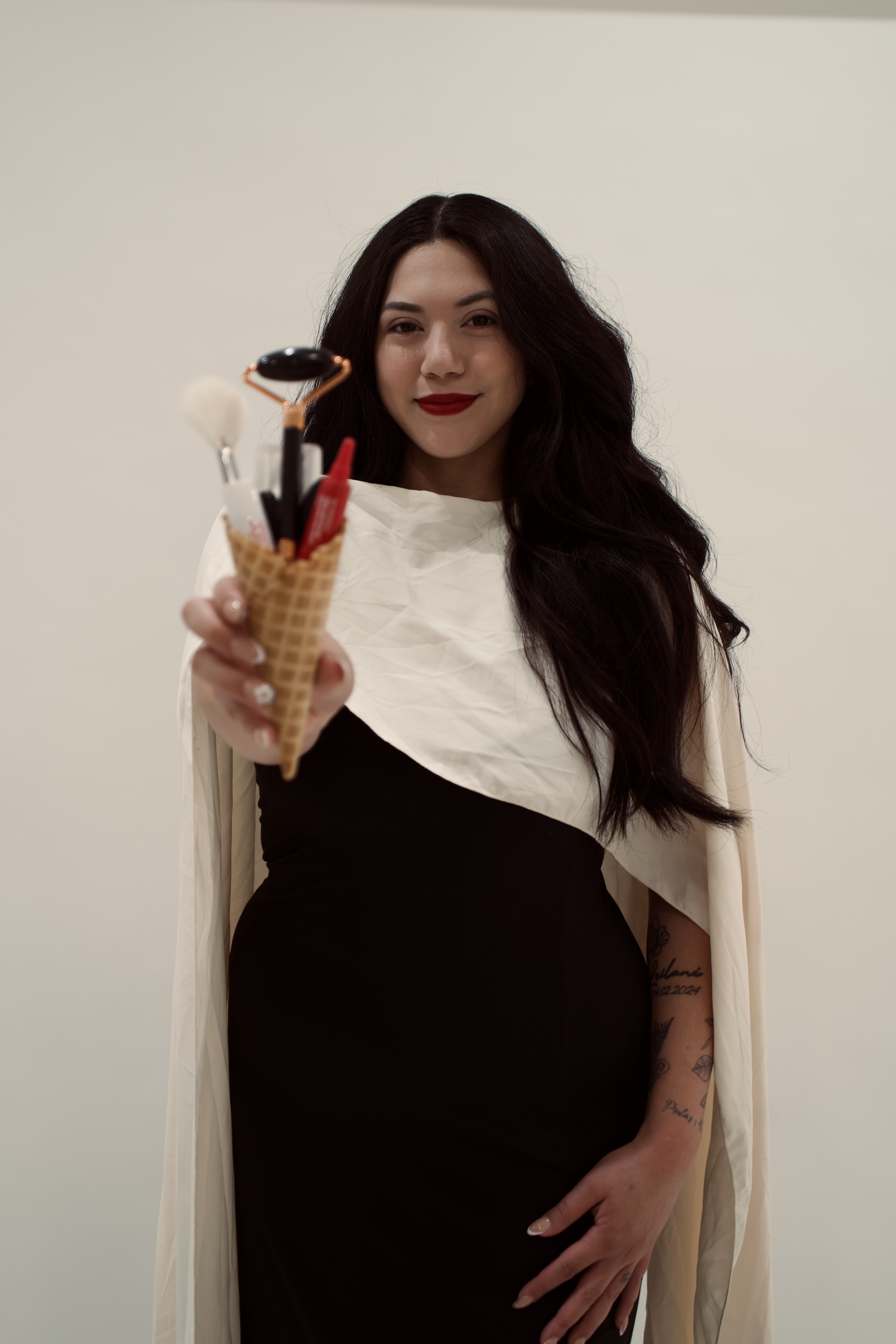 Bianca holding a cone filled with skincare tools