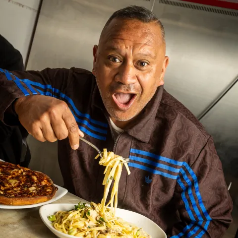 Customer twirling a fork of pasta at Food Corp