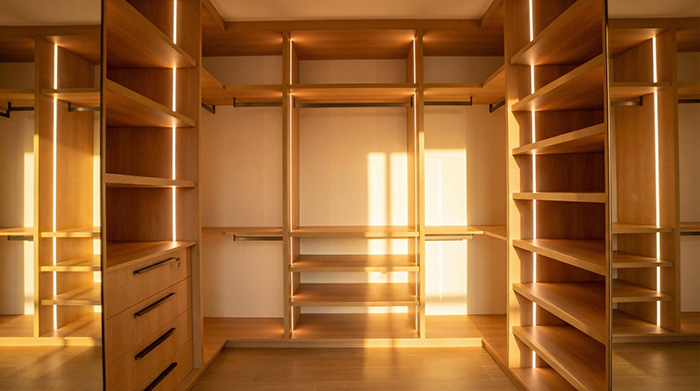 custom wardrobe interior with zoned storage, silent hardware, wall-to-wall fit, warm wood finishes
