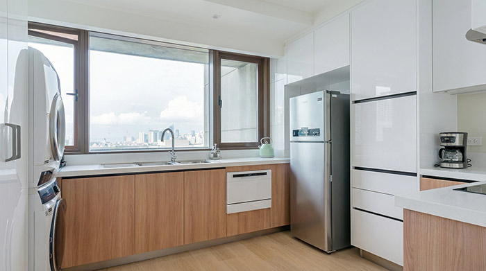 compact modern condo kitchen, 6-9 sqm, efficient layout, integrated appliances, clean lines, warm materials, natural light