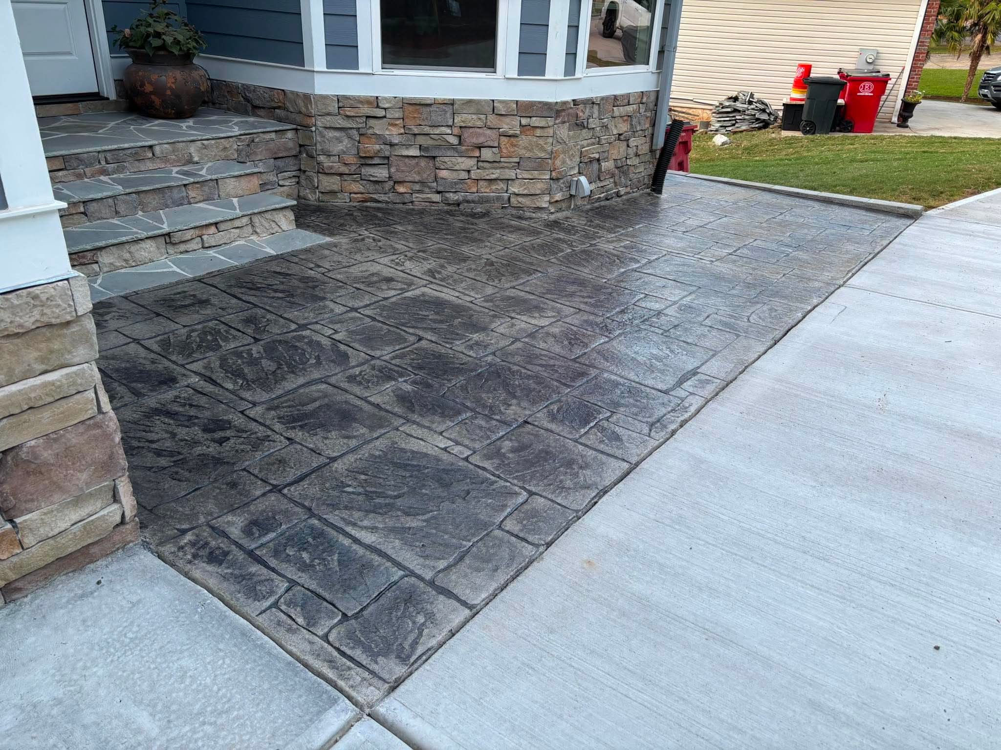 Stamped concrete patio beside a residential home