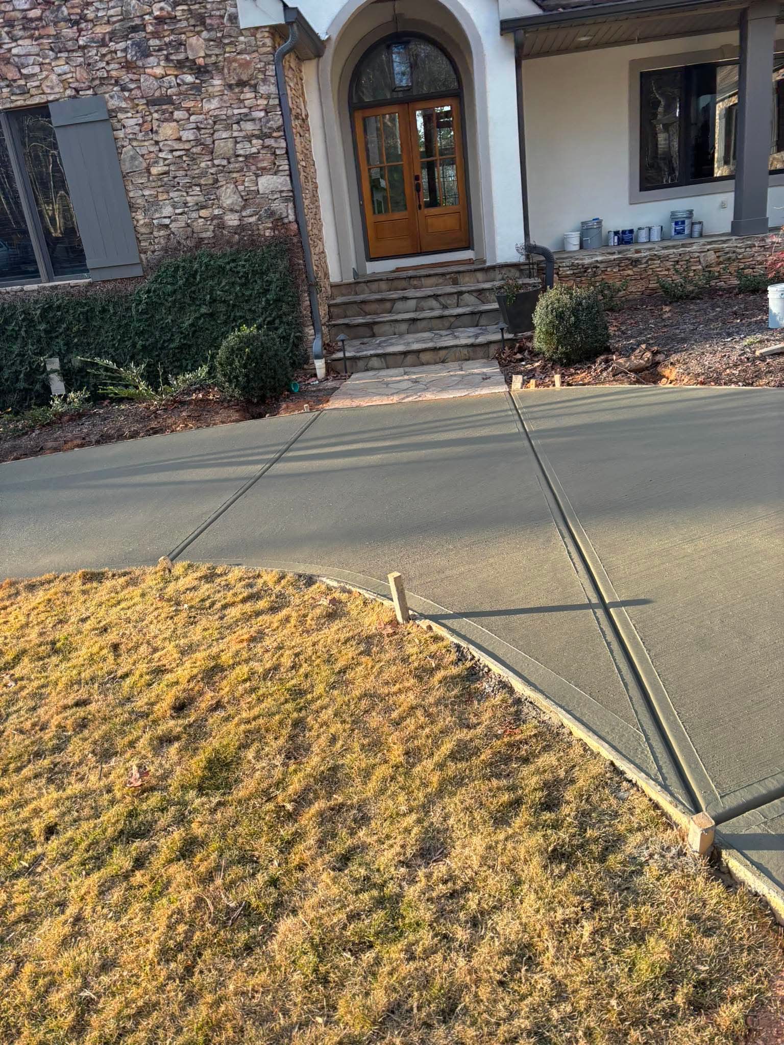 Concrete walkway leading through a yard