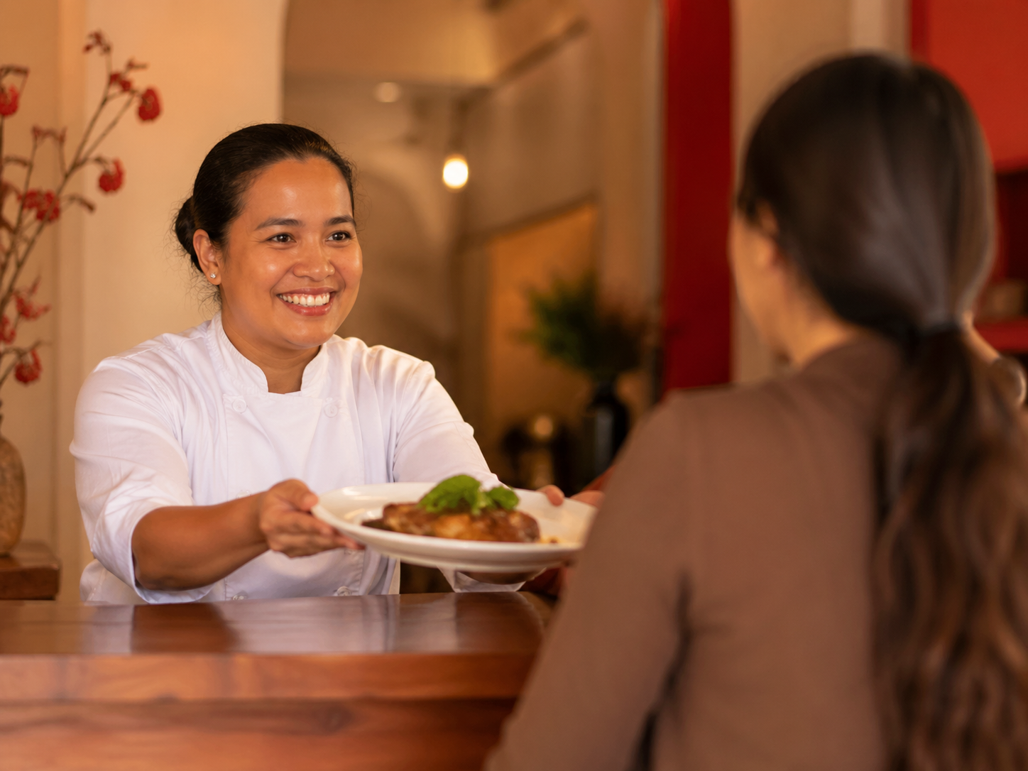 Chef serving a customer at RICE Diner