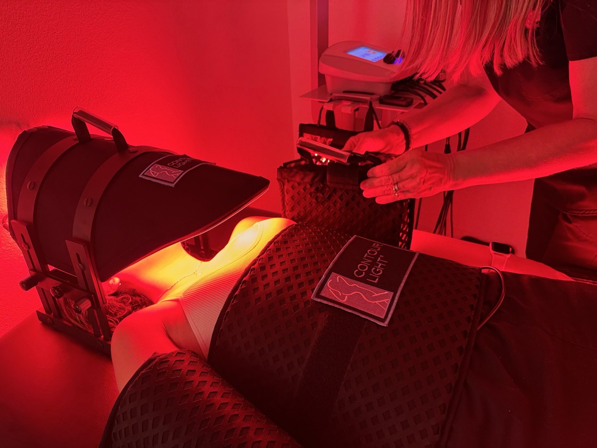 Genesis technician fitting Contour Light pads for a body sculpting session in Cedar Park, TX