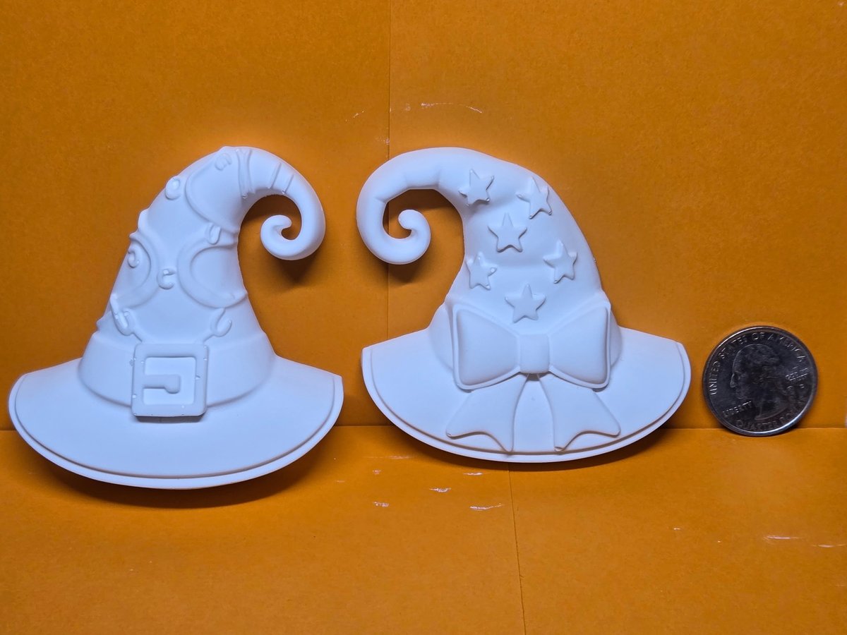Two unpainted plaster witch hats