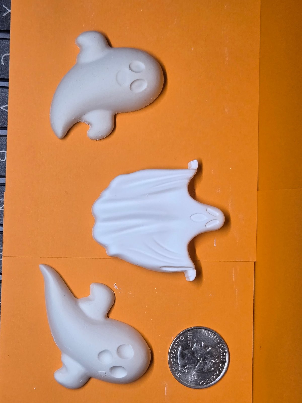 Three small unpainted plaster ghosts