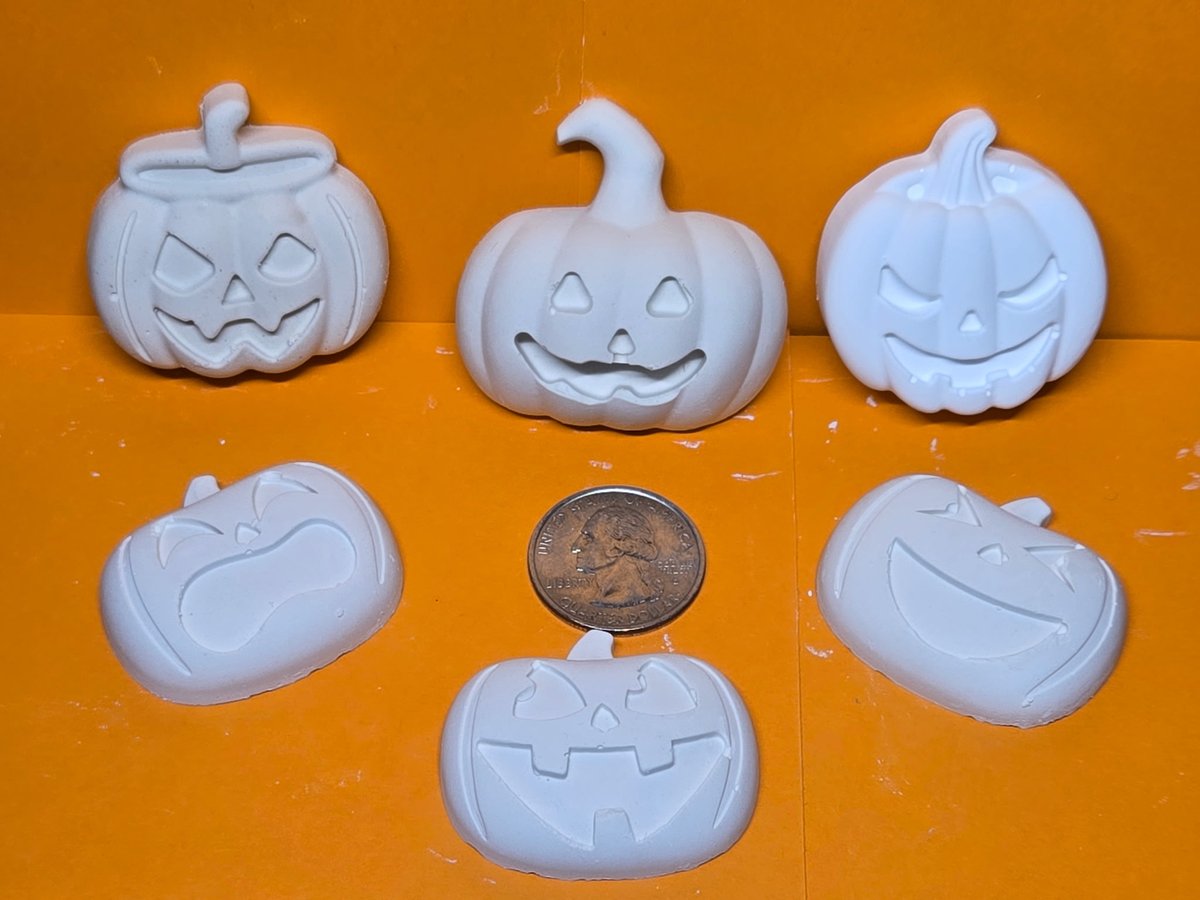 Six unpainted plaster jack-o'-lantern pieces ready to paint