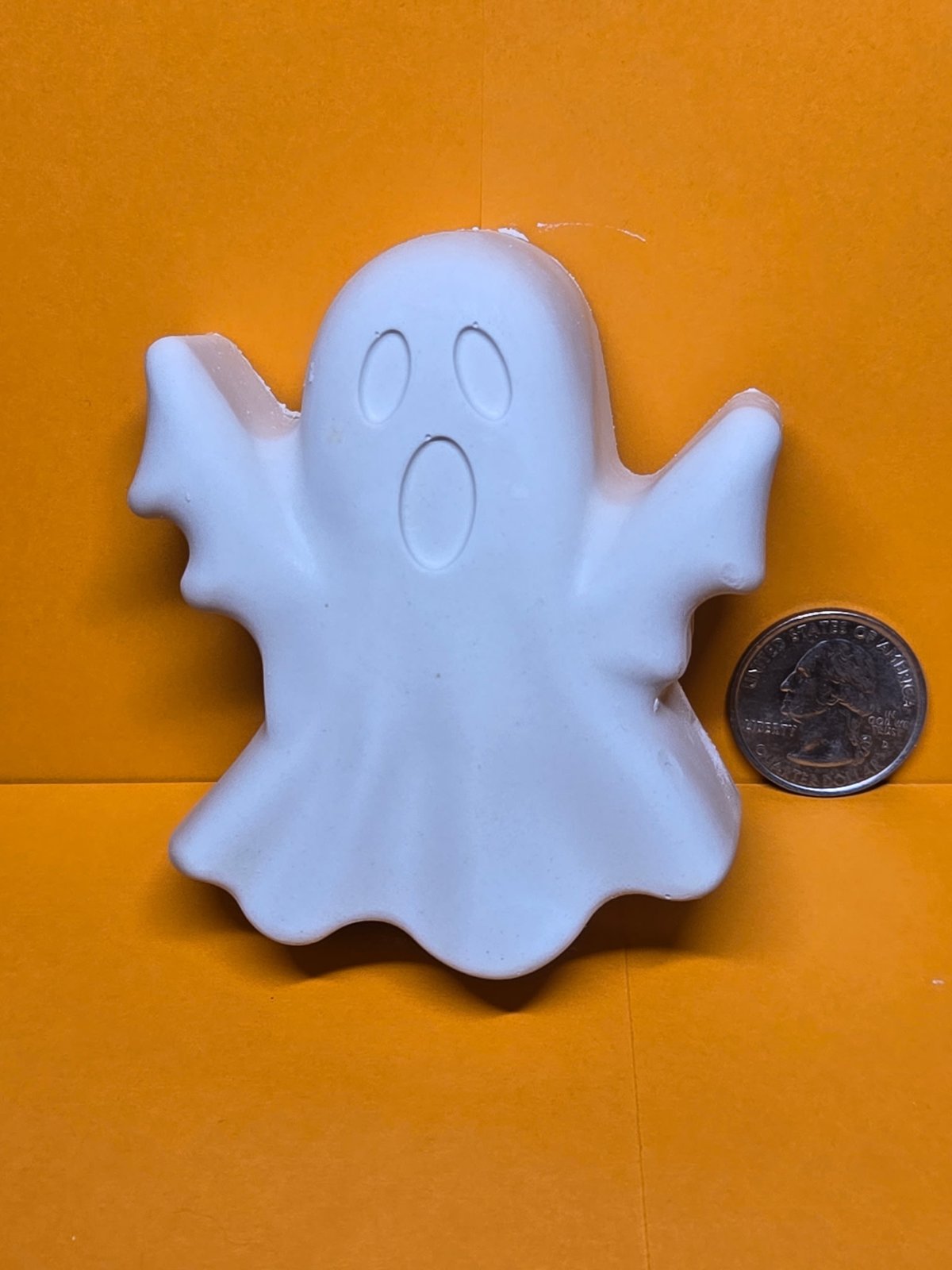 Large unpainted plaster ghost with arms raised