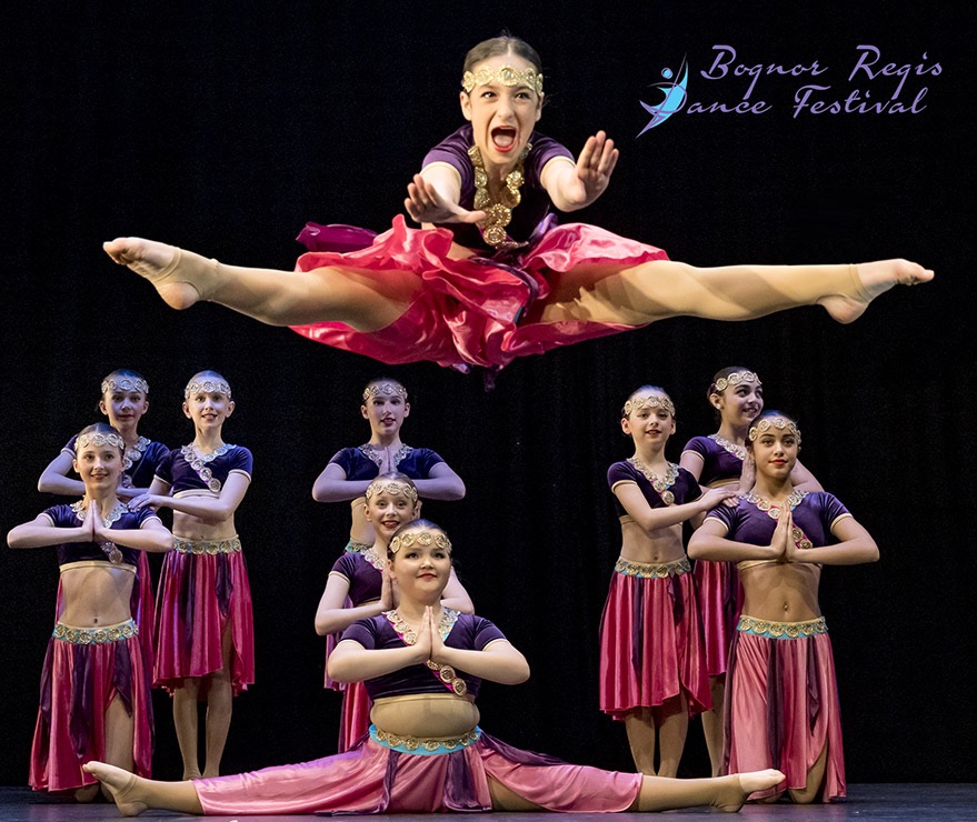 Group of dancers with a dancer leaping