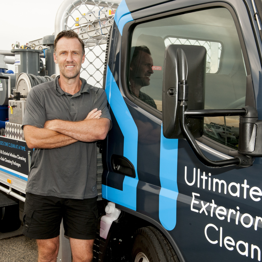 Armin, owner of Ultimate Exterior Clean, standing beside the company truck