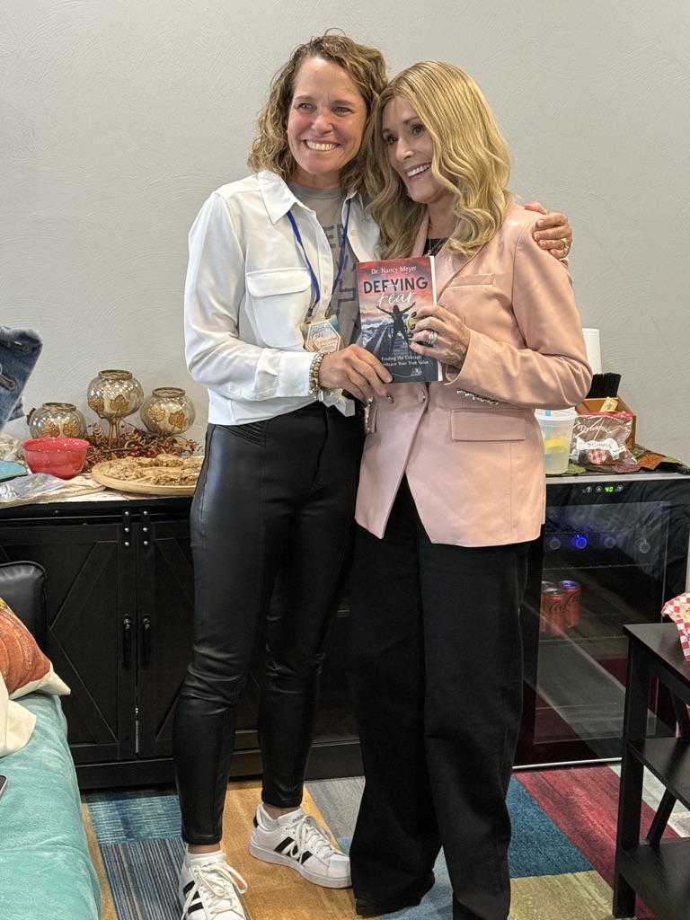 Dr. Nancy Meyer and Sheila Walsh holding the book Defying Fear
