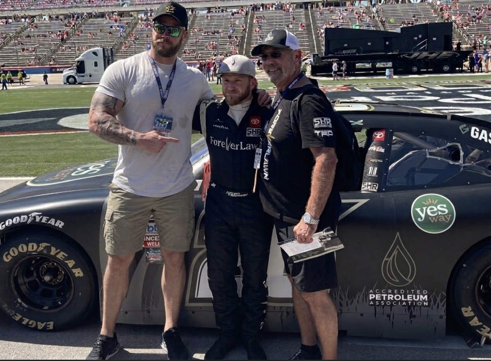 Jesse Johnson-Brower with Jeffrey Earnhardt and team owner Sam Hunt on the NASCAR track