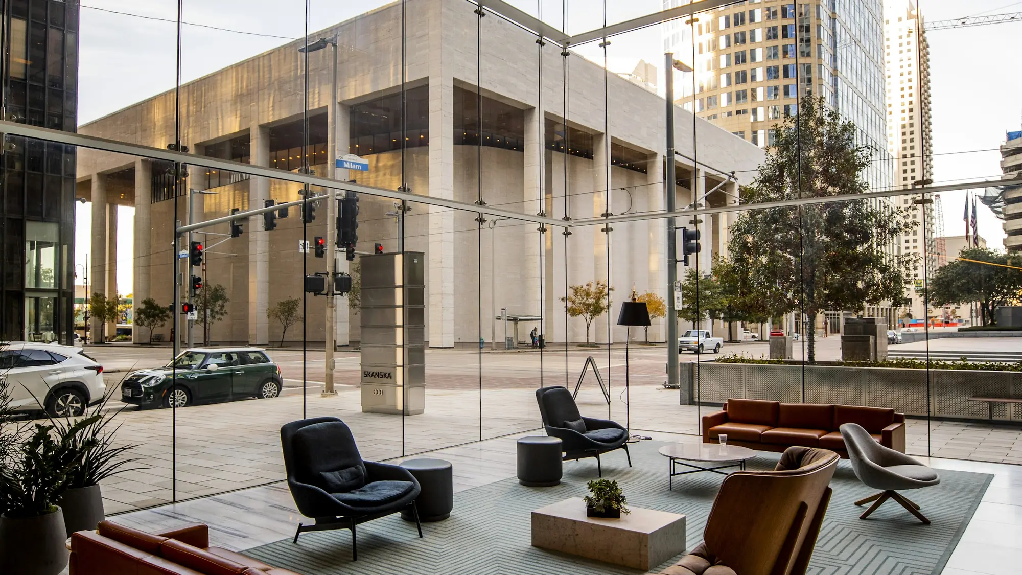 A modern lounge with leather seating and full-height glass onto the street.