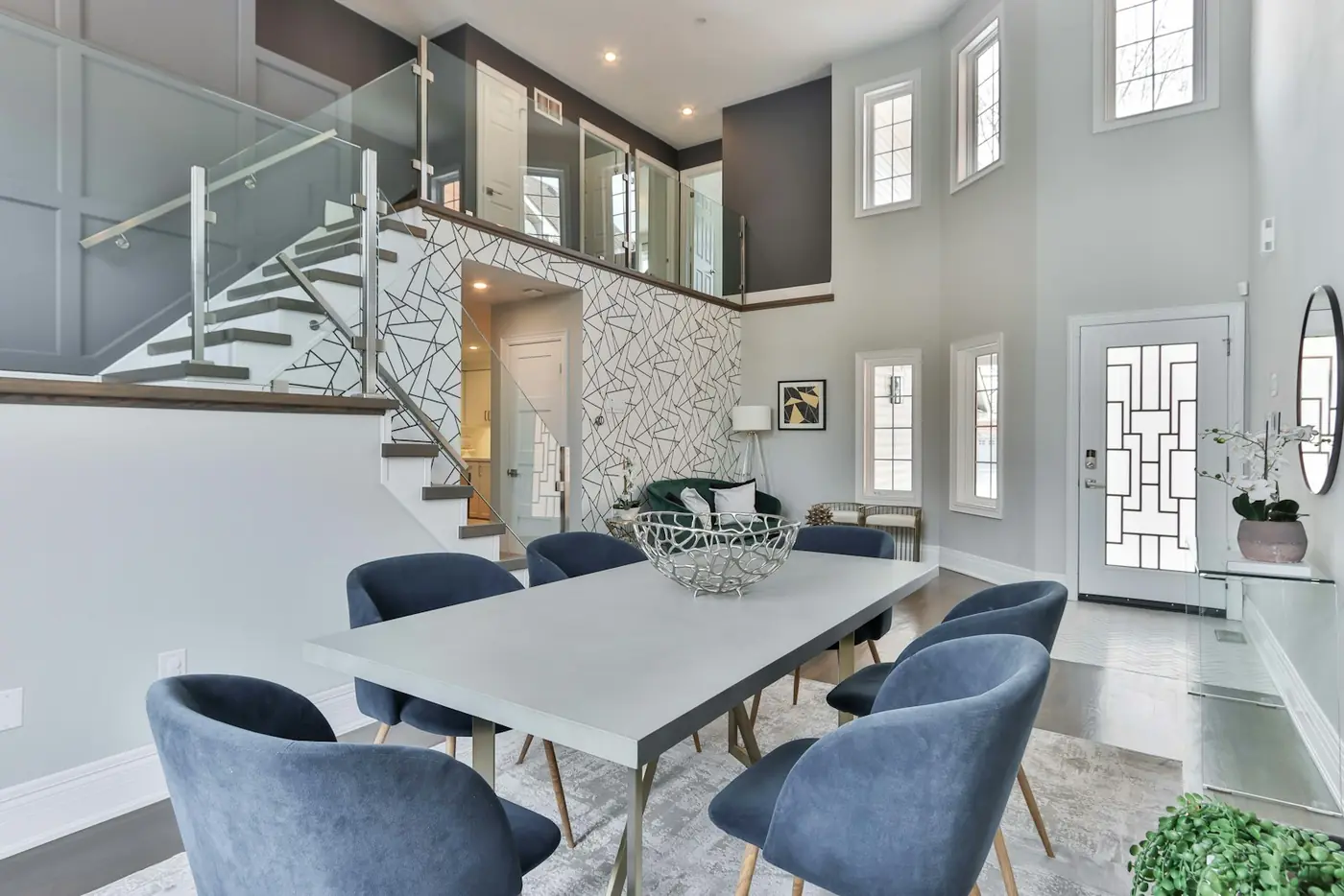A dining room staged with a black timber table and sculptural chairs.