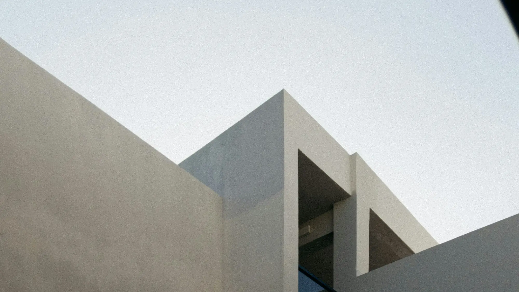 A warm concrete architectural detail meeting open sky.