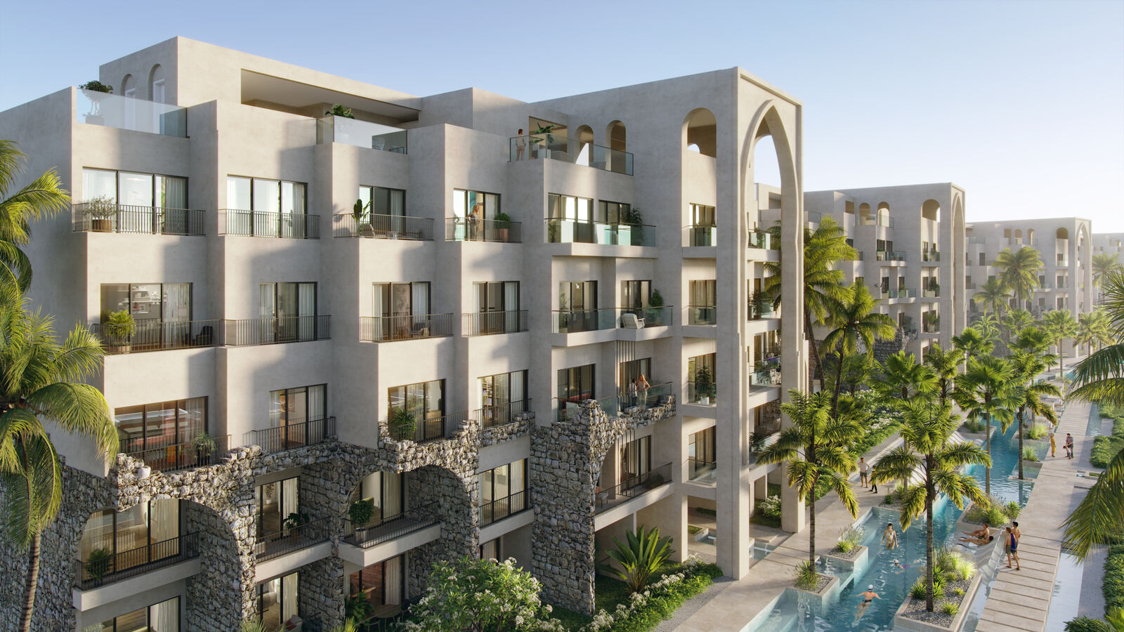 Fachada de las residencias Poseidonia con arcos de piedra y palmeras