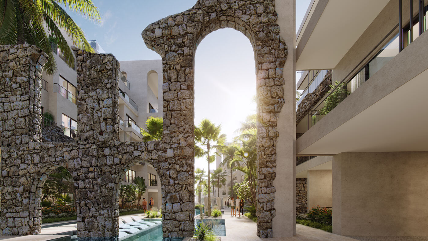 Pasillo con arcos de piedra hacia la piscina