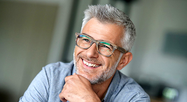 Middle-aged man wearing glasses smiling