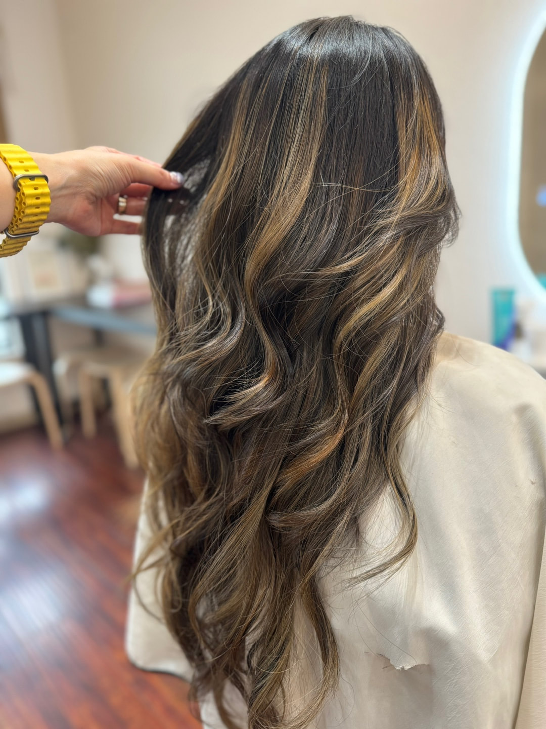 Long brown waves with lighter ribbons, back view.
