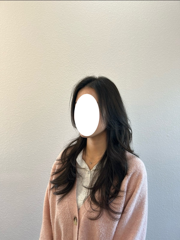Long dark waves with the face obscured by the existing image's white oval.
