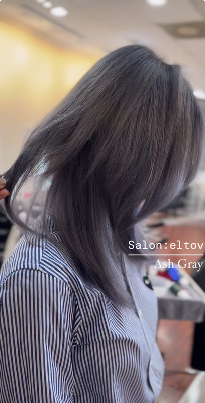 Side/back view of shoulder-length dark ash-toned hair.