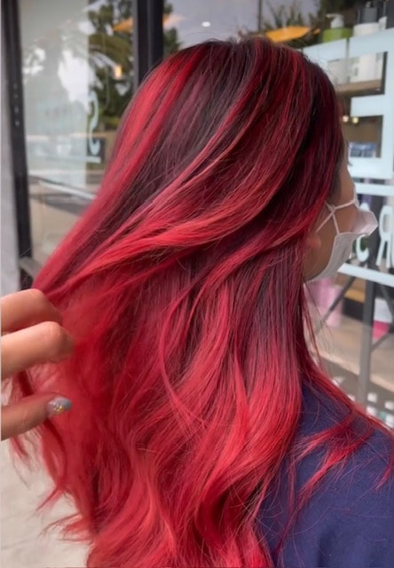Long red-toned hair, back view.