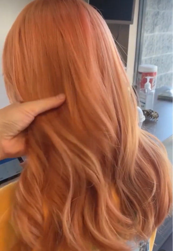 Long copper-toned waves, back view.