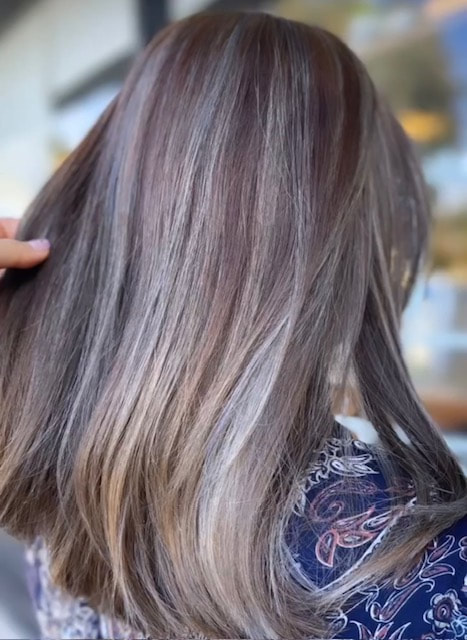 Long brown/ash hair with lighter ribbons, back view.
