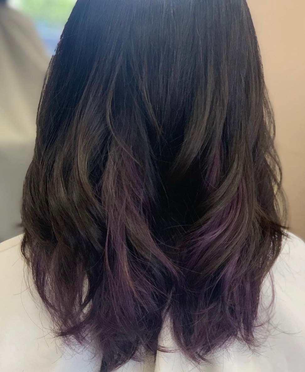 Dark layered hair with purple ends, back view.