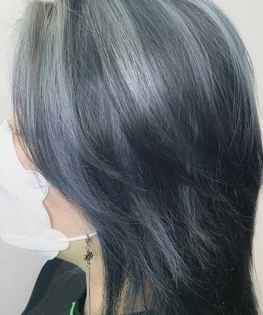 Dark cool-toned layered hair, side/back view.
