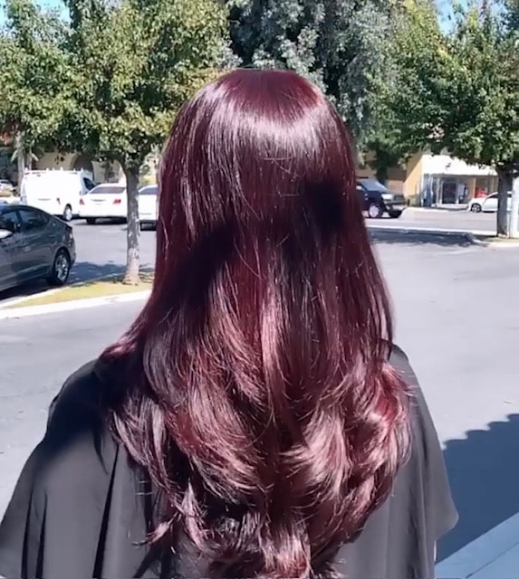 Glossy dark burgundy-toned waves photographed outdoors.