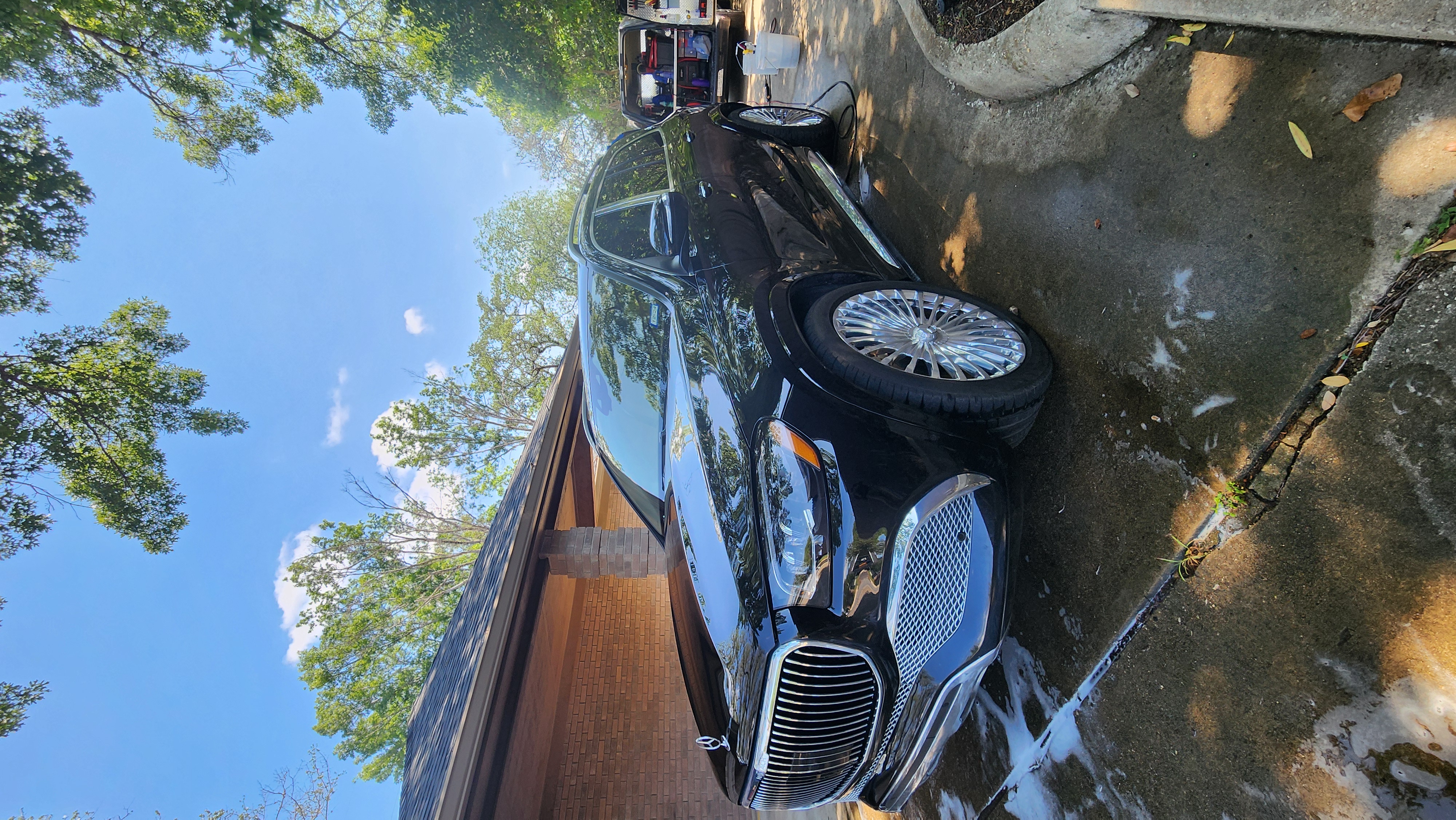 Hydrophobic ceramic coating shedding water on a new vehicle protected by Auto Dude