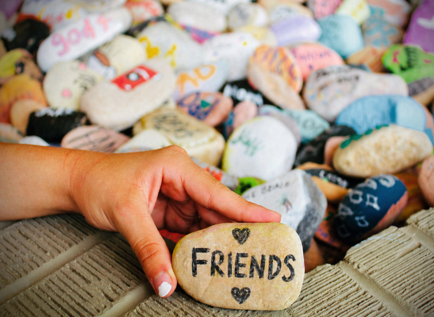 rock with friends painted on it betwee hearts