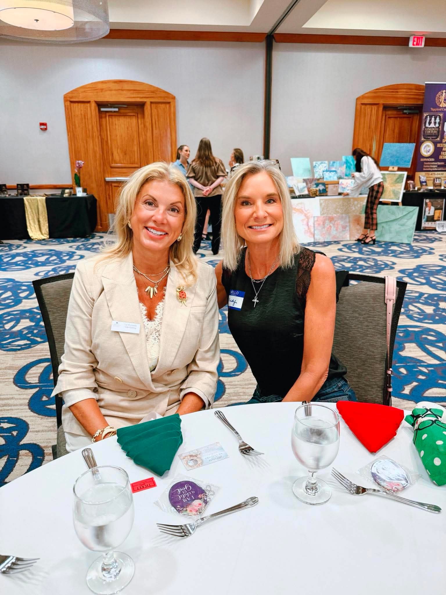 Two ACBW members smiling together at their table