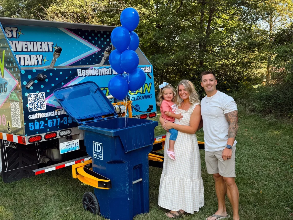 A happy family of three stands smiling beside a Swift Can Cleaning truck with a blue trash can and balloons.