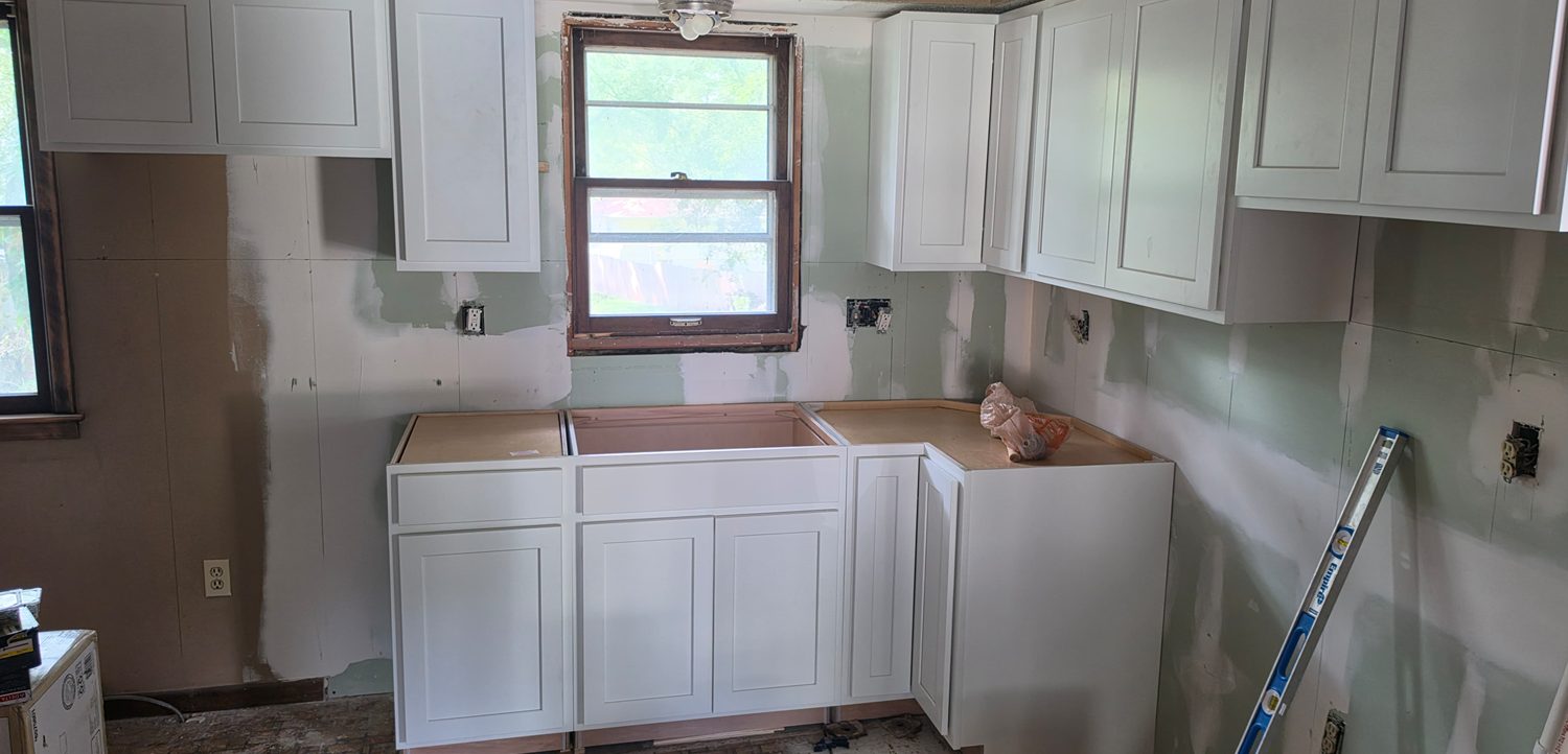 White shaker cabinets installed during an in-progress kitchen renovation.
