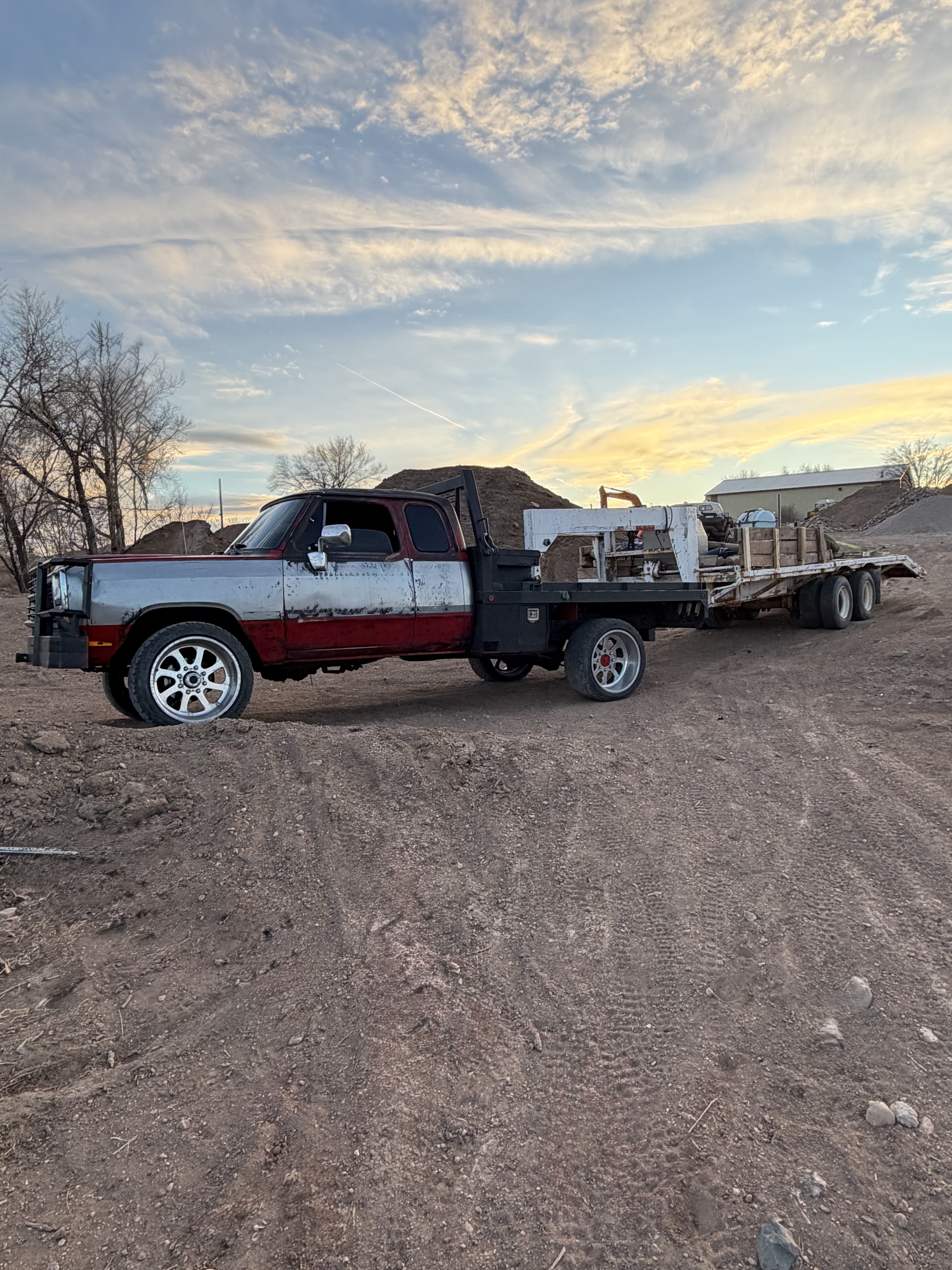 A truck and enclosed trailer in evening light.