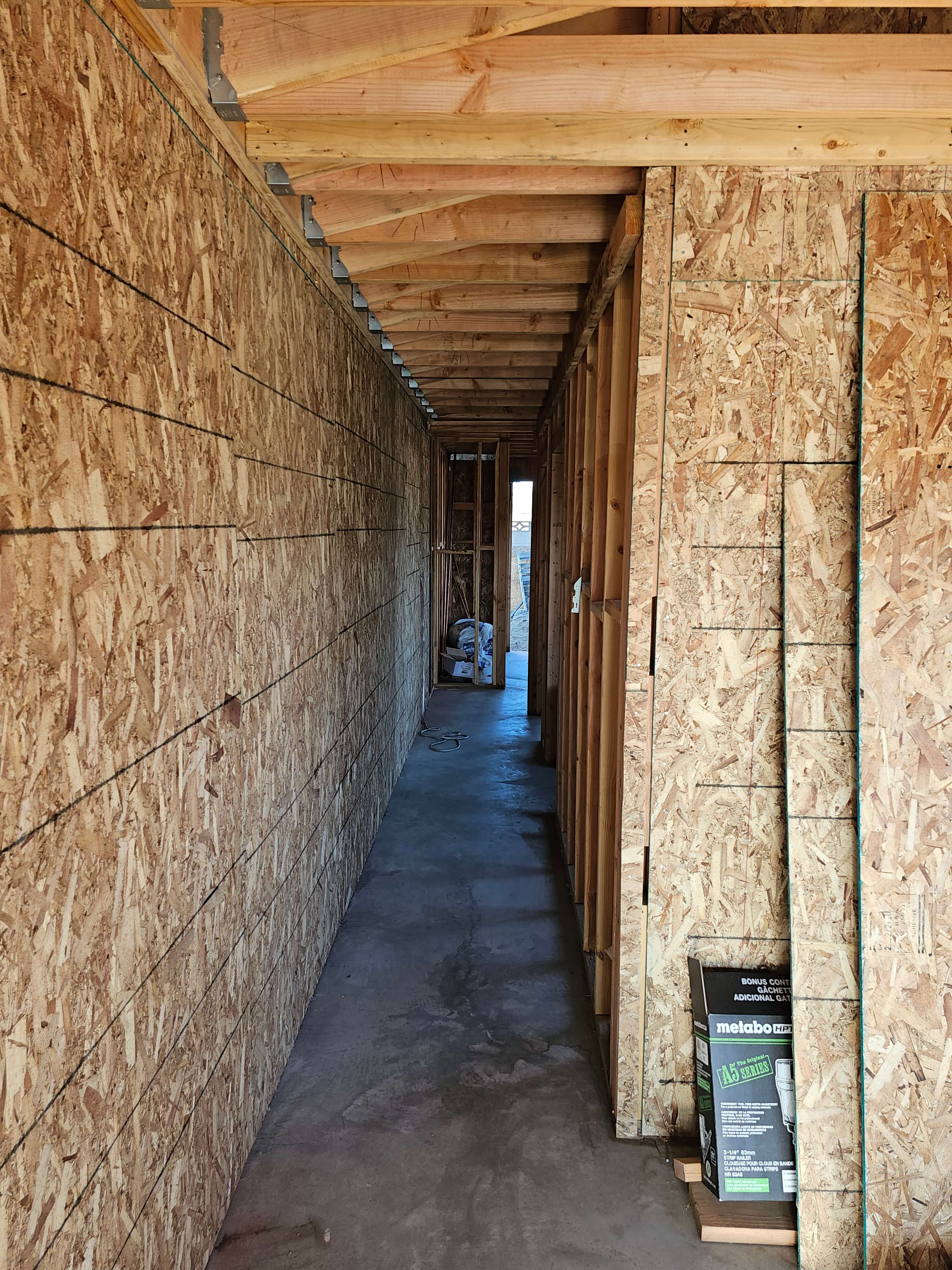 Ontario — hallway under construction, plywood walls