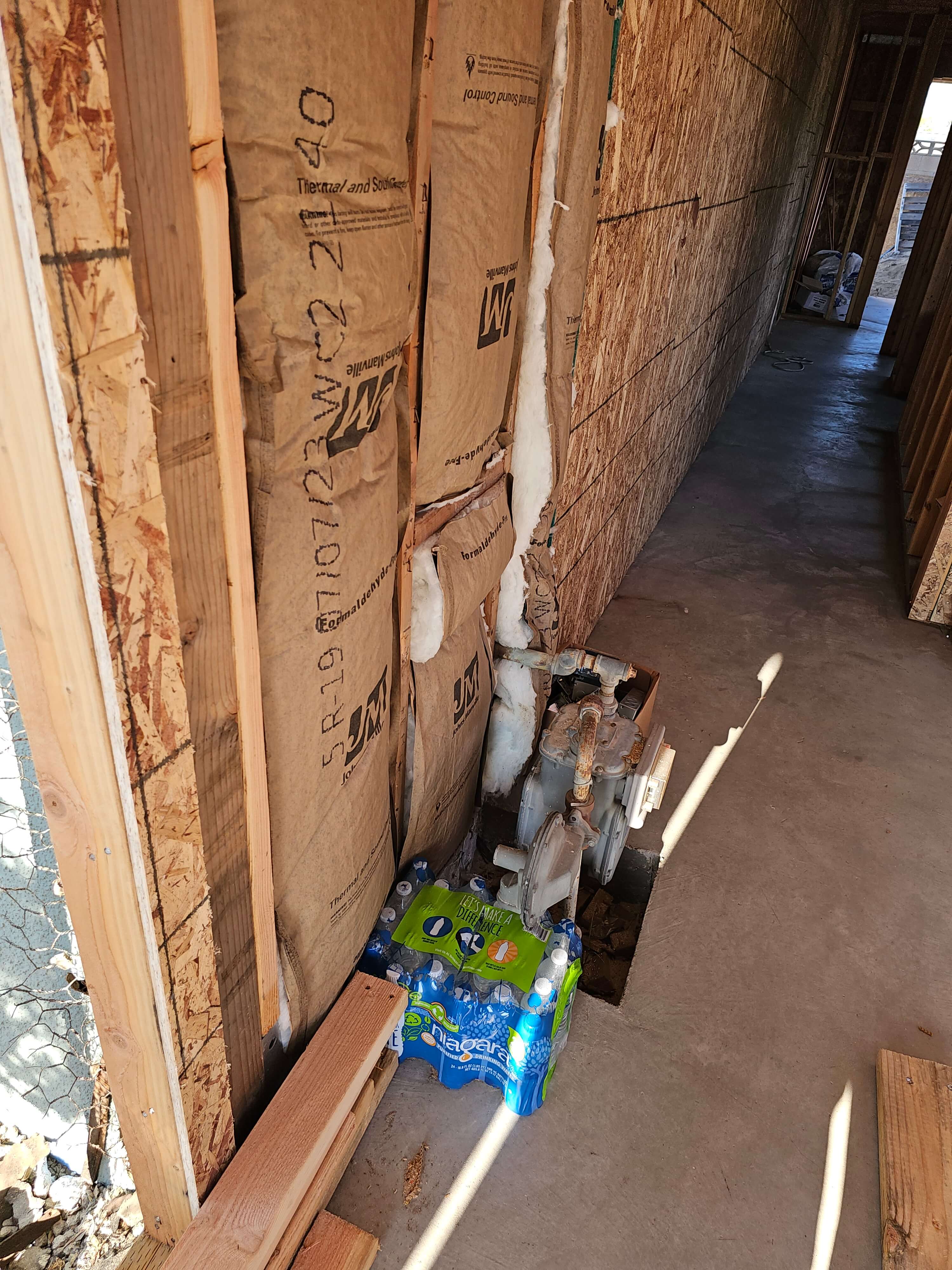 Pomona — insulation and gas meter on utility wall