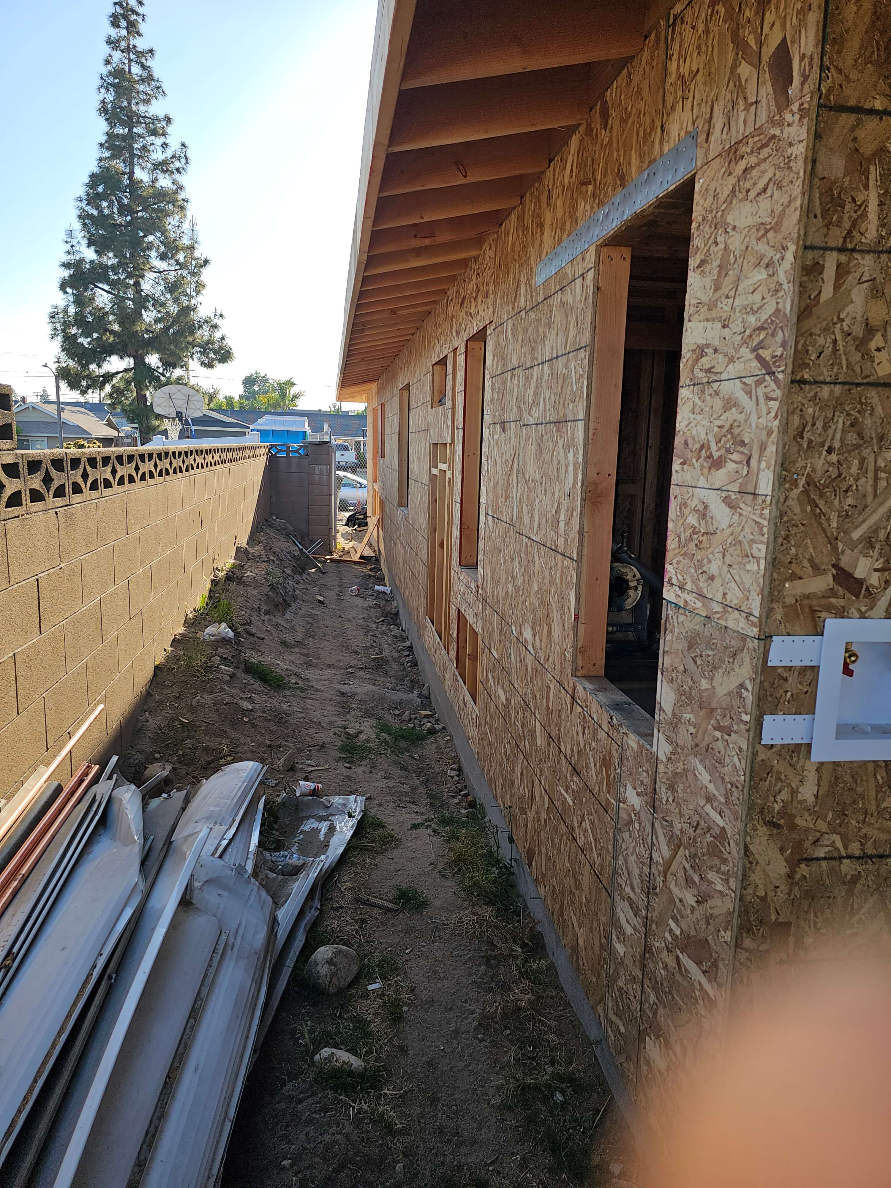 Ontario — OSB sheathed exterior wall beside decorative block wall