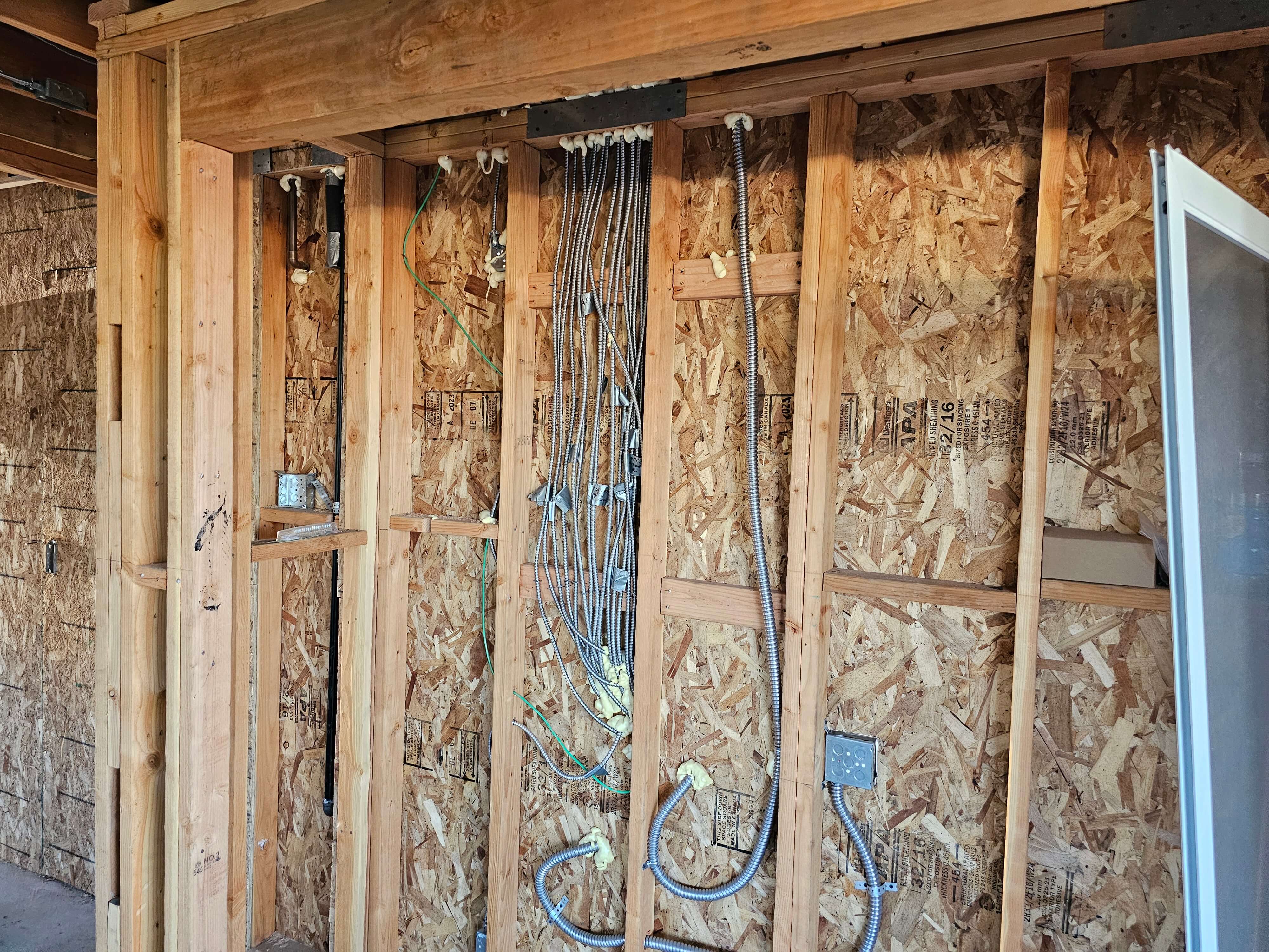 Pomona — MC electrical conduits routed from top plate to junction boxes