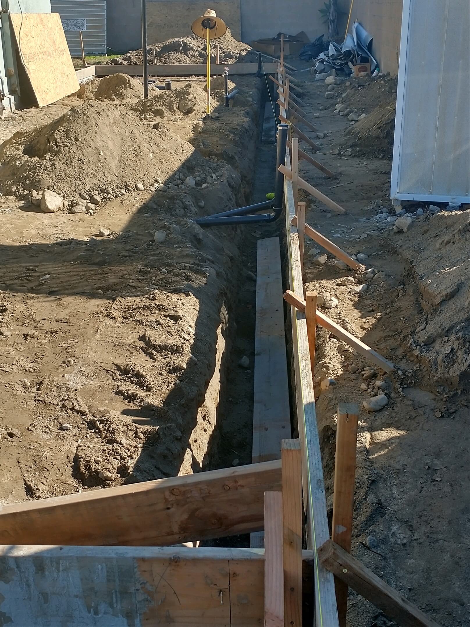 Ontario — foundation trench showing footing forms and underground ABS sewer pipes