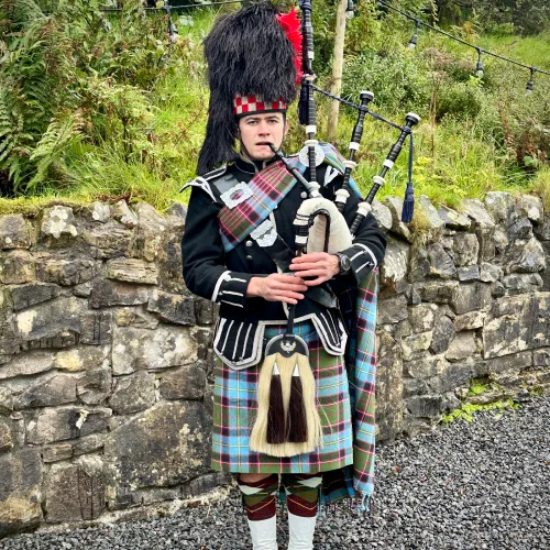 AWDJ bagpiper in full Highland dress at a wedding