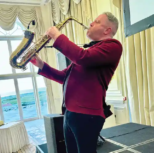 AWDJ saxophonist performing at a wedding