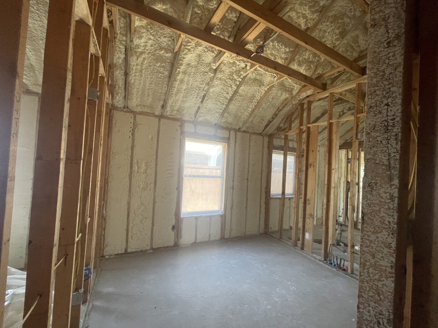 Interior framing with new spray foam insulation during the rebuild